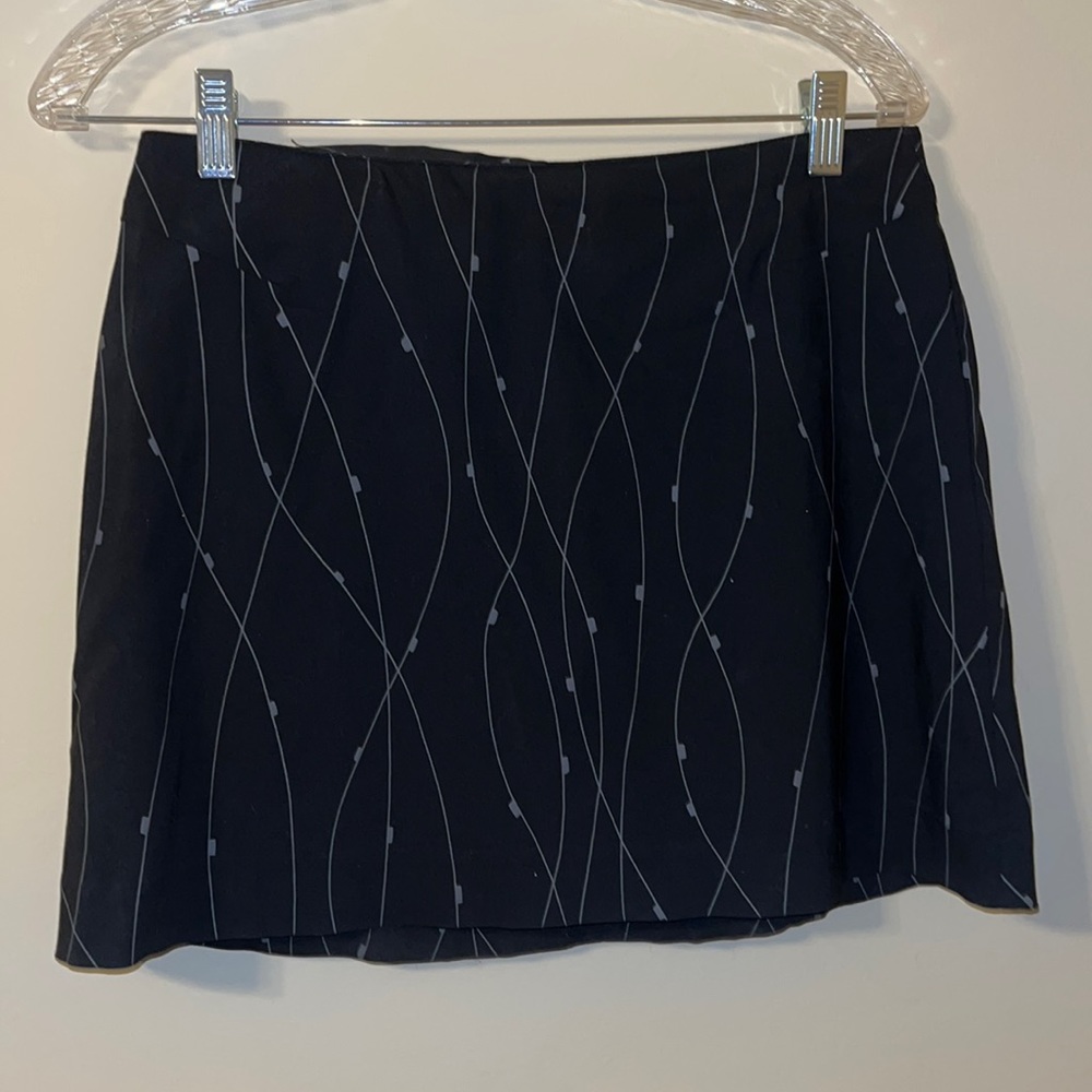 Black skirt with lines on it and zipper on the back